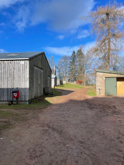 Red markers and arrows (like the one seen on the right hand building) guide you to the beginning of the hill walk, just past the holiday cottages