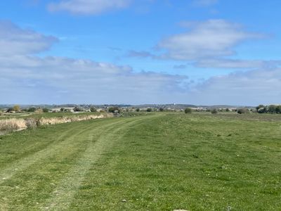 The flat marshland at Pevensey Levels, with Herstmonceux science centre on the horizon